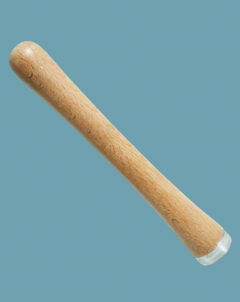 wooden muddler on a blue background
