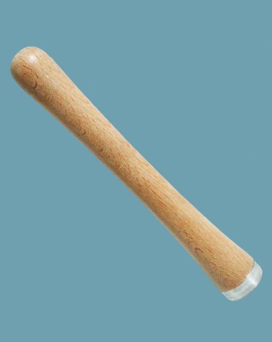 wooden muddler on a blue background