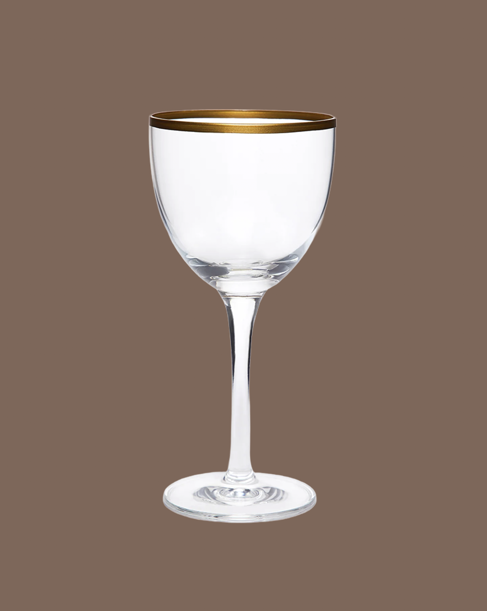 Clear wine glass with gold rim on a brown background