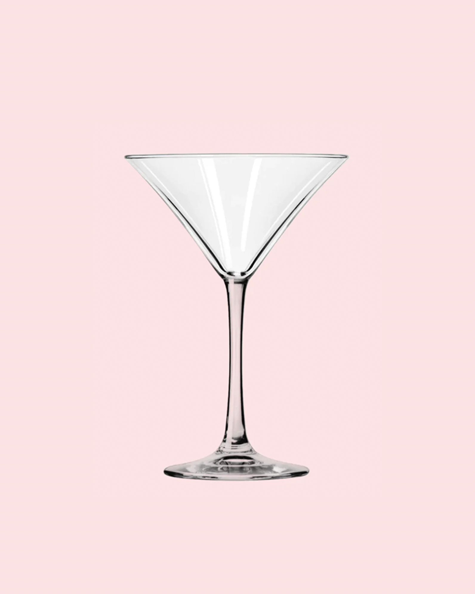 Clear martini glass on a pink background