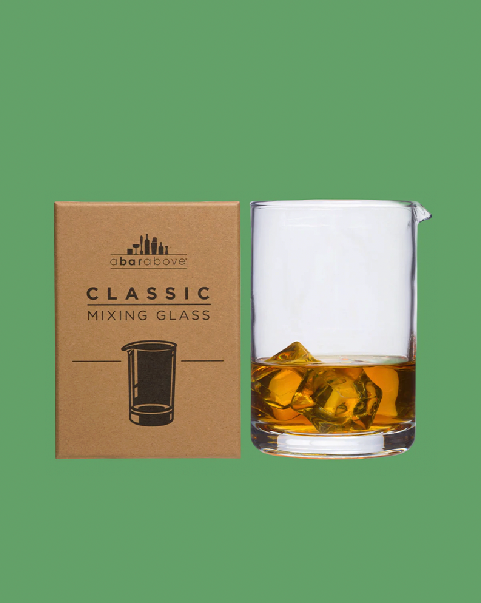 Classic mixing glass with ice cubes next to its box on a green background