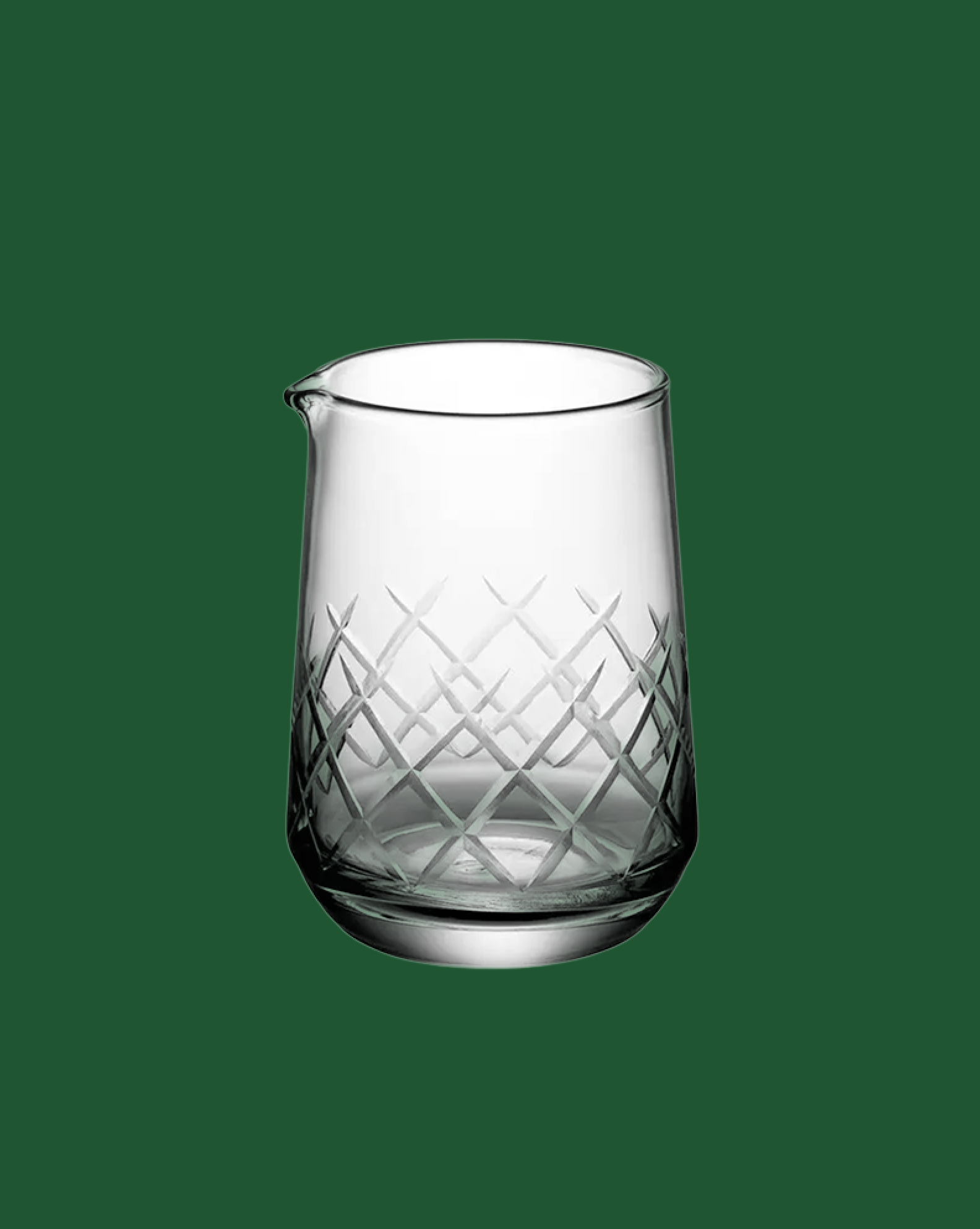 Clear glass pitcher with diamond pattern on a green background