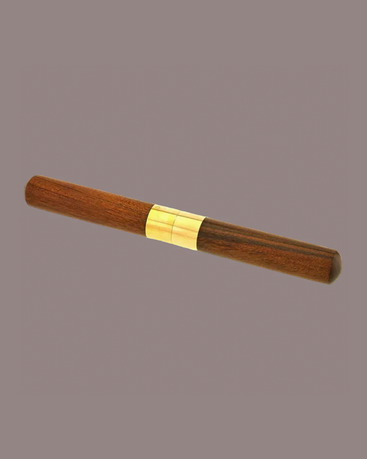 Wooden pen with gold accent on a gray background