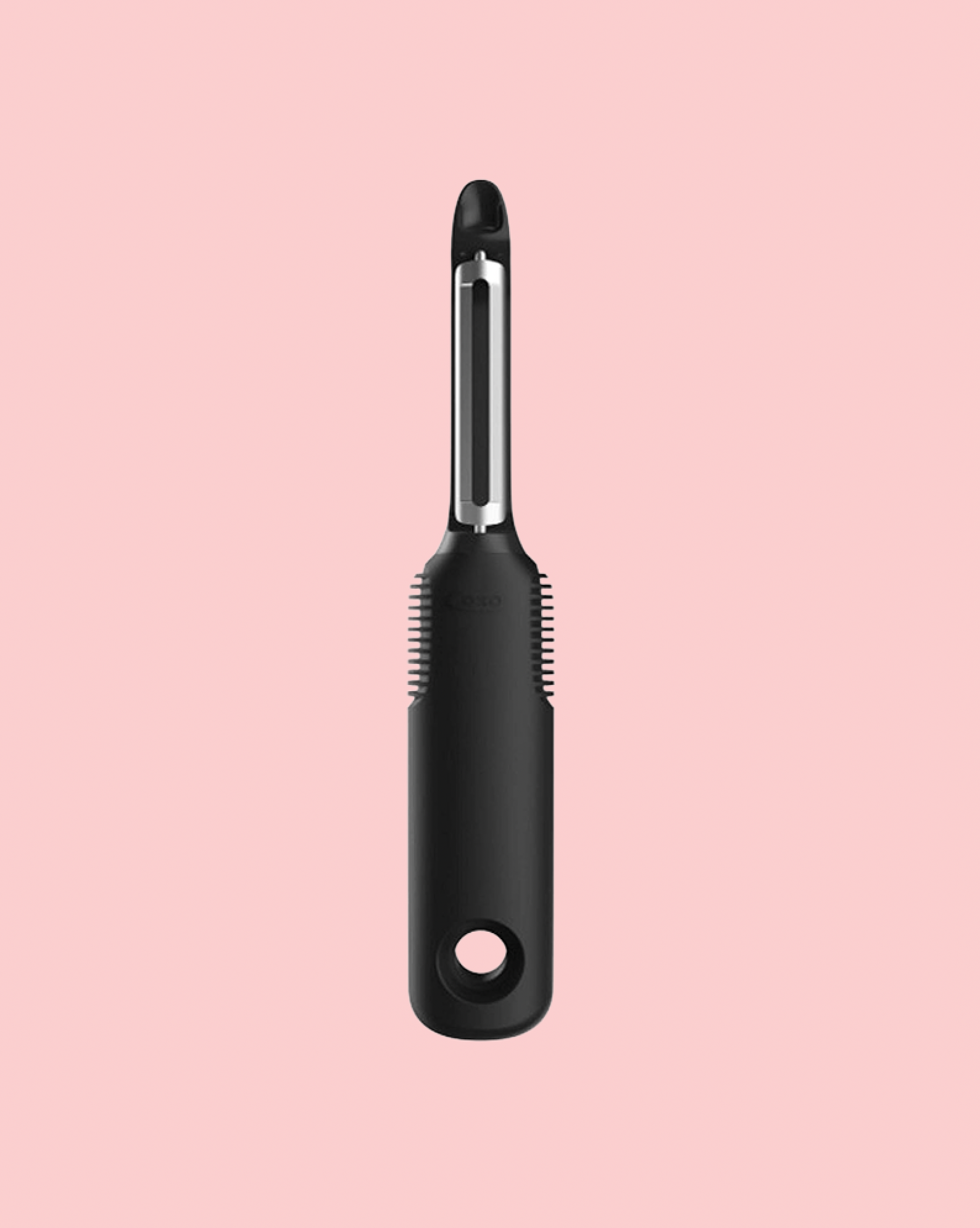 veggie peeler on pink background