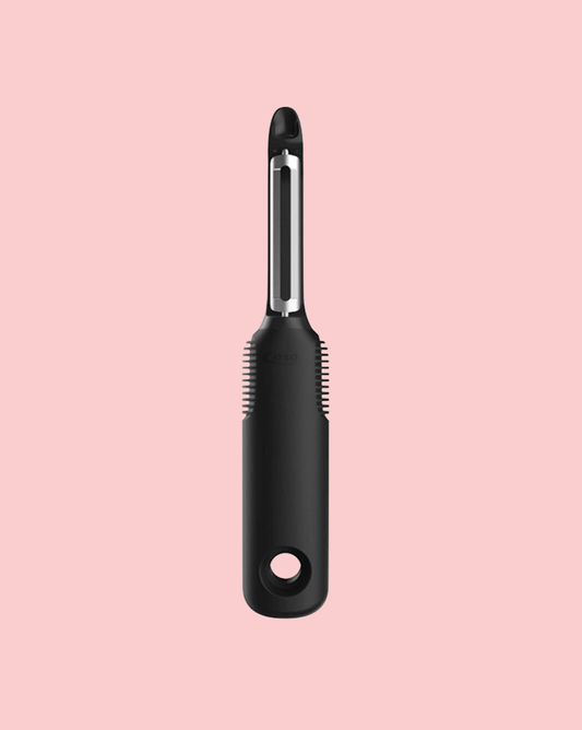 veggie peeler on pink background
