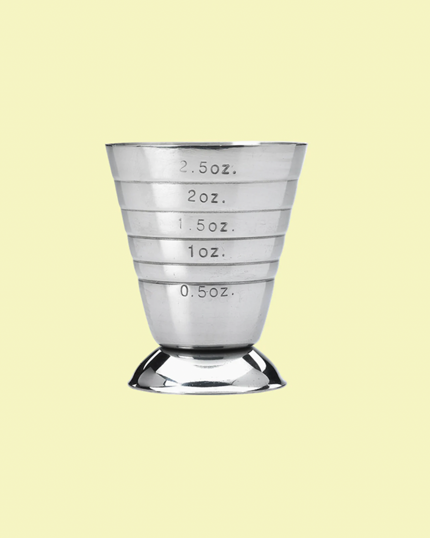 Metallic measuring cup with volume markings on a light yellow background