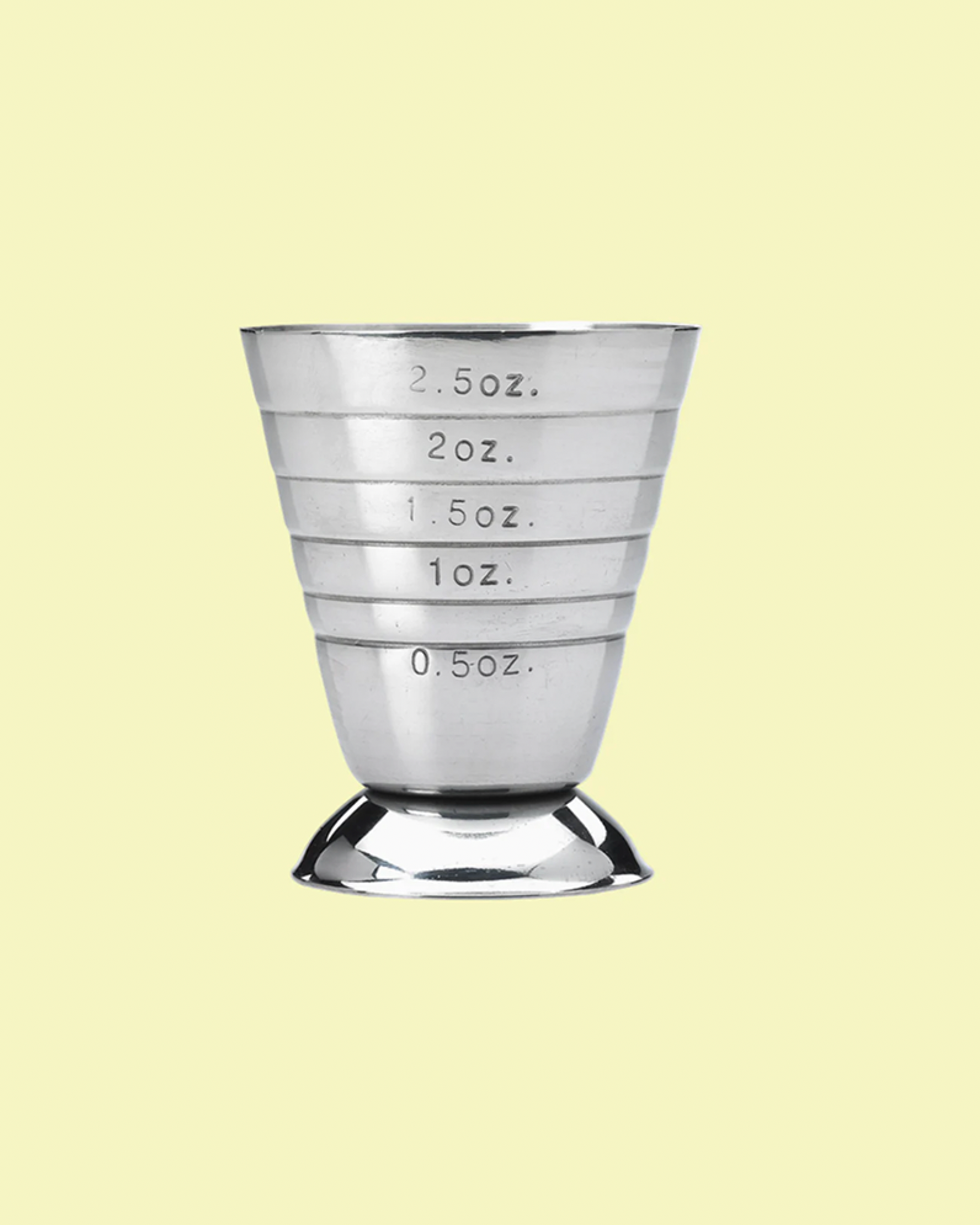 Metallic measuring cup with volume markings on a light yellow background