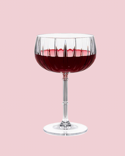 Glass of red wine on a pink background