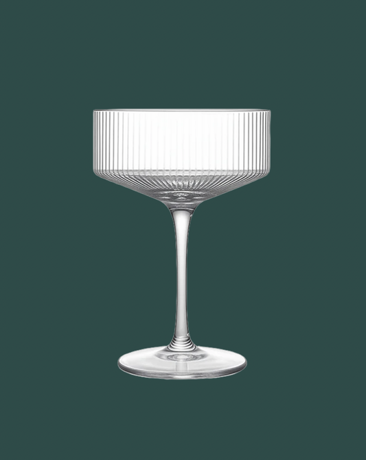 Clear glass with ribbed design on a dark green background
