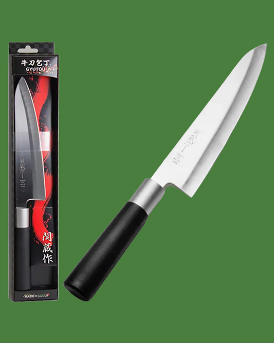 Chef's knife with black handle and silver blade next to its packaging on a green background