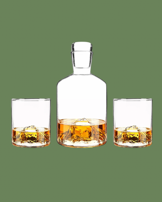 Whiskey decanter and glasses on a green background