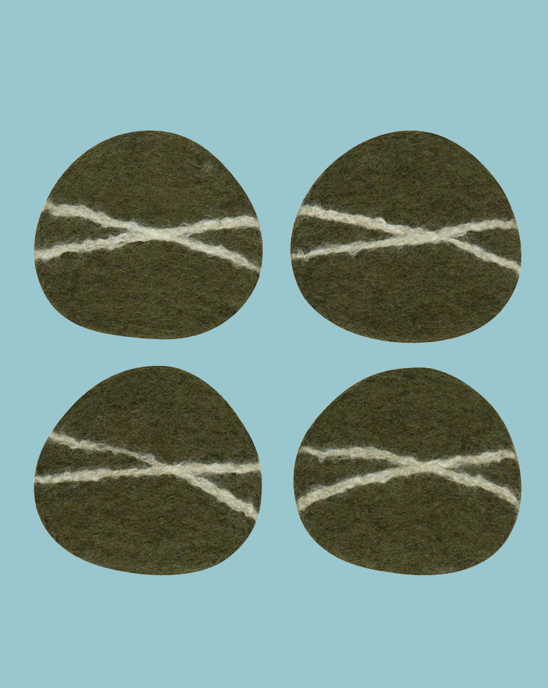 Four green circular patches with white stitching on a light blue background