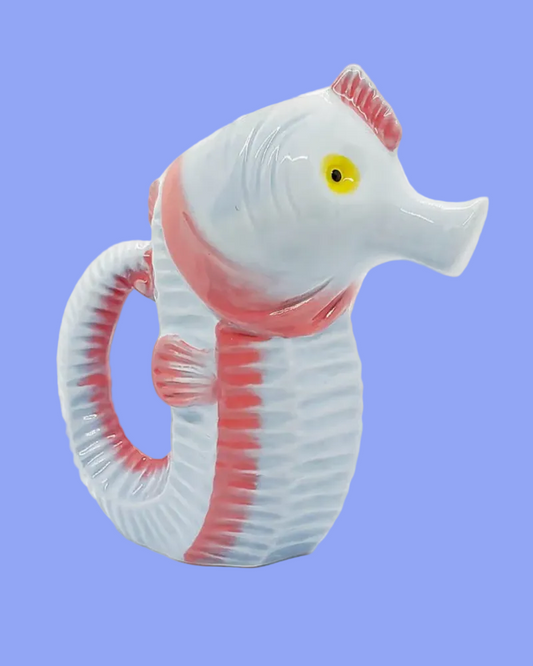 Model of a seahorse with pink and red stripes on a blue background