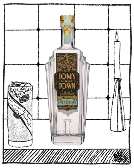 Clear glass bottle of Tom's Town vodka on a black and white background